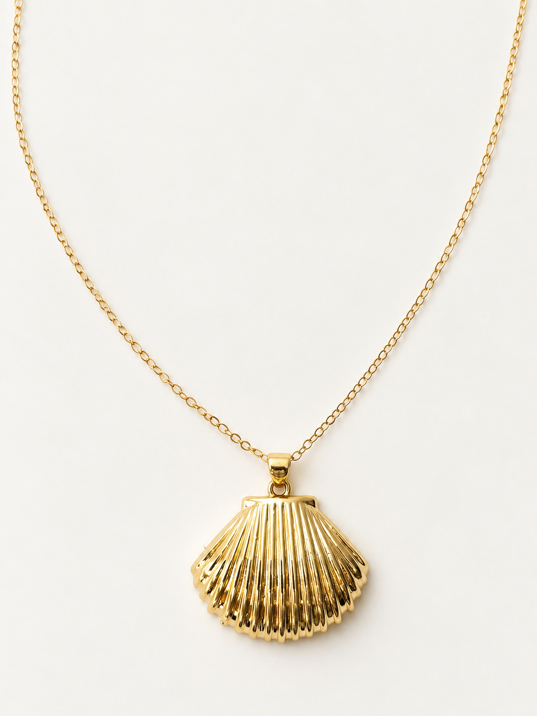 Close-up of the textured gold-filled scallop shell pendant
