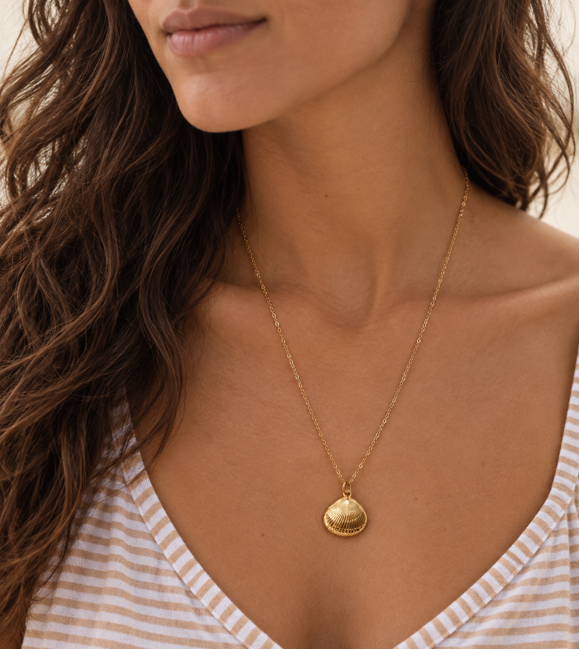 Gold-filled clam shell necklace worn by a model